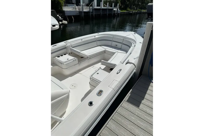 Slide: The Image of 2013 Intrepid 375 Center Console boat docked, featuring spacious seating and sleek design. - 18