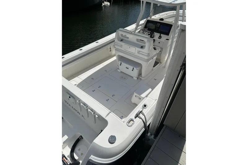 Slide: The Image of 2013 Intrepid 375 Center Console boat with spacious deck and modern controls. - 21