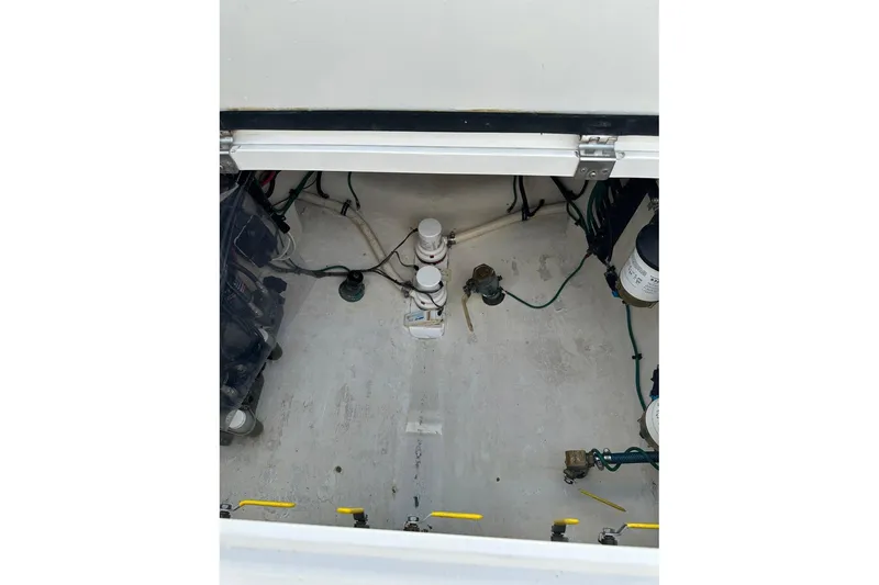 Slide: The Image of Engine compartment of a 2013 Intrepid 375 Center Console boat, showing mechanical components. - 24