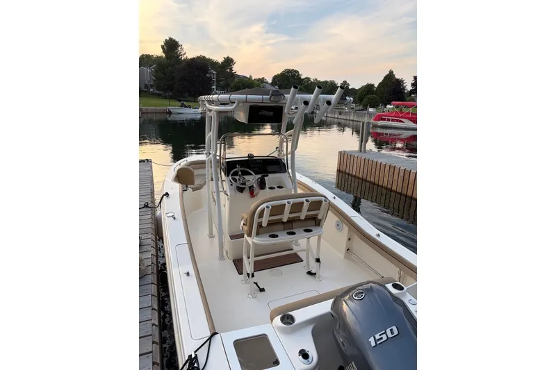 Slide: The Image of 2018 Scout 215 XSF boat docked at sunset, featuring a 150 horsepower engine. - 4