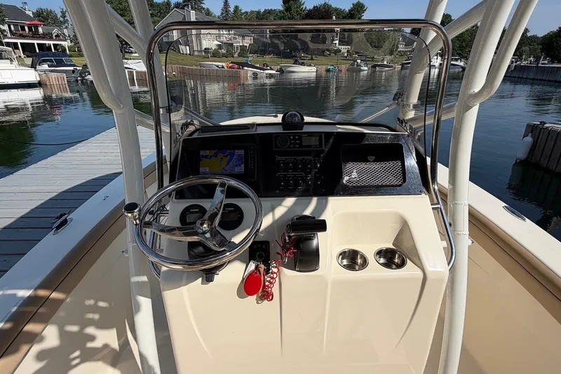 Slide: The Image of 2018 Scout 215 XSF boat dashboard with steering wheel and navigation system. - 12