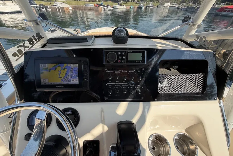Slide: The Image of 2018 Scout 215 XSF boat dashboard with navigation controls and Garmin GPS display. - 14
