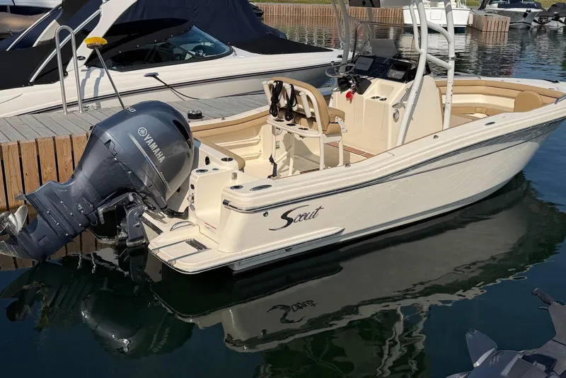 Slide: The Image of 2018 Scout 215 XSF boat with Yamaha outboard motor docked at marina. - 1