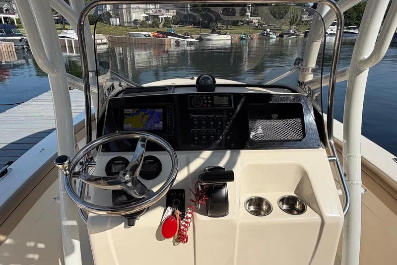 Slide: The Image of 2018 Scout 215 XSF boat dashboard with steering wheel and navigation system. - 13