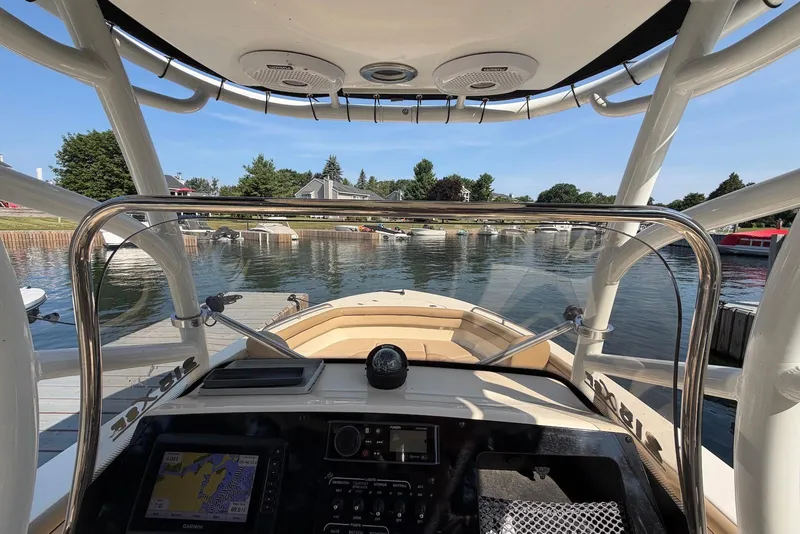 Slide: The Image of 2018 Scout 215 XSF boat docked, view from helm with navigation system. - 15