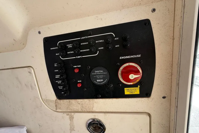 Slide: The Image of Control panel of a 2018 Scout 215 XSF boat with various switches and dials. - 29