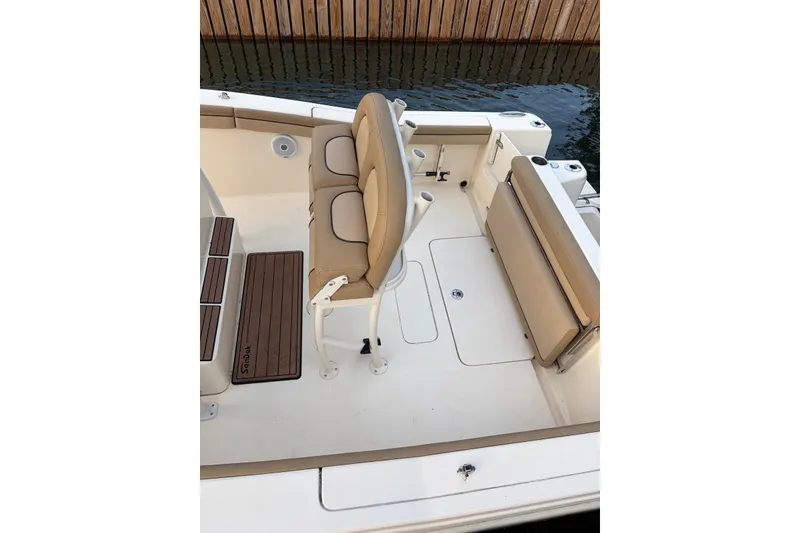 Slide: The Image of 2018 Scout 215 XSF boat interior with beige seating and wooden accents. - 6