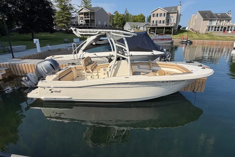 Slide: The Image of 2018 Scout 215 XSF boat docked in a scenic residential marina. - 3