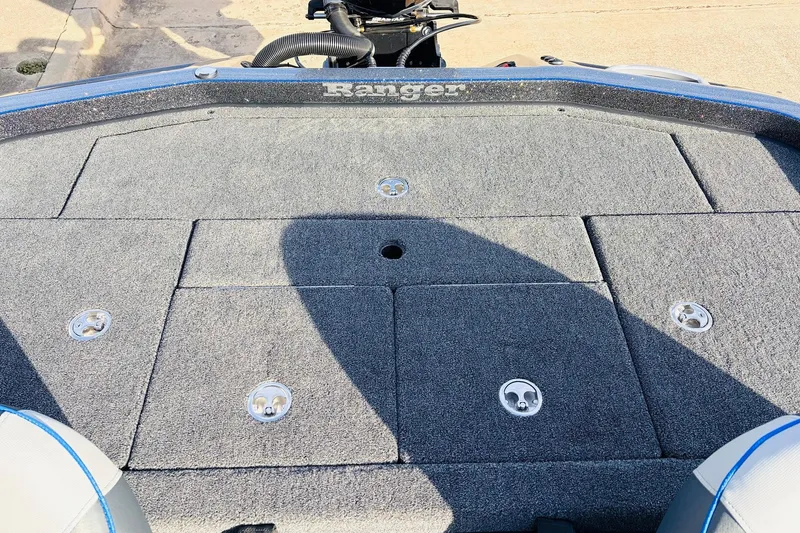 Slide: The Image of 2026 Ranger Z521 boat deck with carpeted surface and storage compartments. - 52
