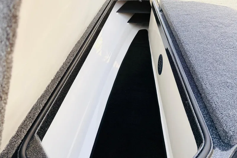 Slide: The Image of 2026 Ranger Z521 boat storage compartment with carpeted interior and sleek design. - 21