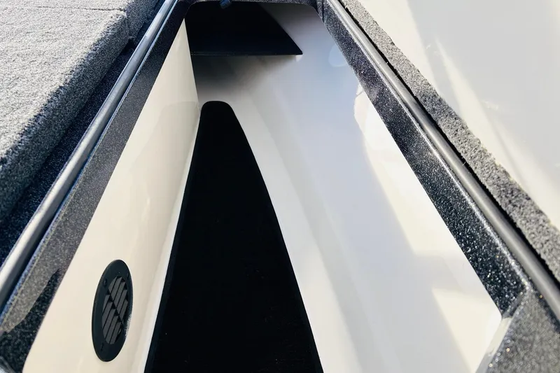 Slide: The Image of 2026 Ranger Z521 boat storage compartment with carpeted interior and ventilation. - 26