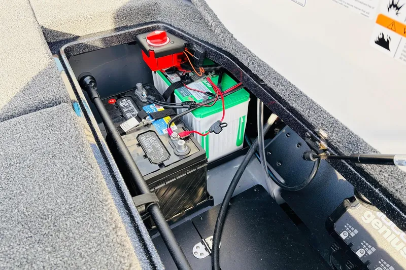 Slide: The Image of Battery compartment of 2026 Ranger Z521 boat, featuring dual batteries and wiring setup. - 64