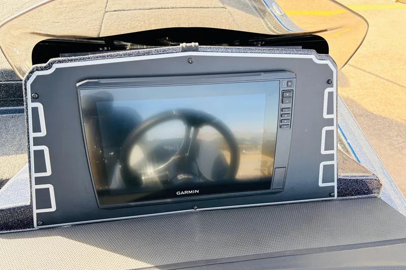 Slide: The Image of 2026 Ranger Z521 boat dashboard with Garmin display and steering wheel reflection. - 43