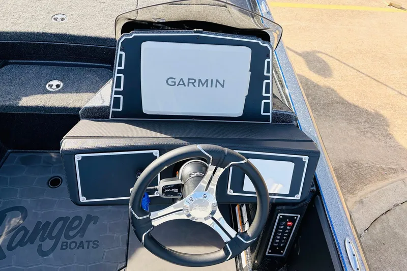 Slide: The Image of 2026 Ranger Z521 boat dashboard with Garmin navigation system and steering wheel. - 42