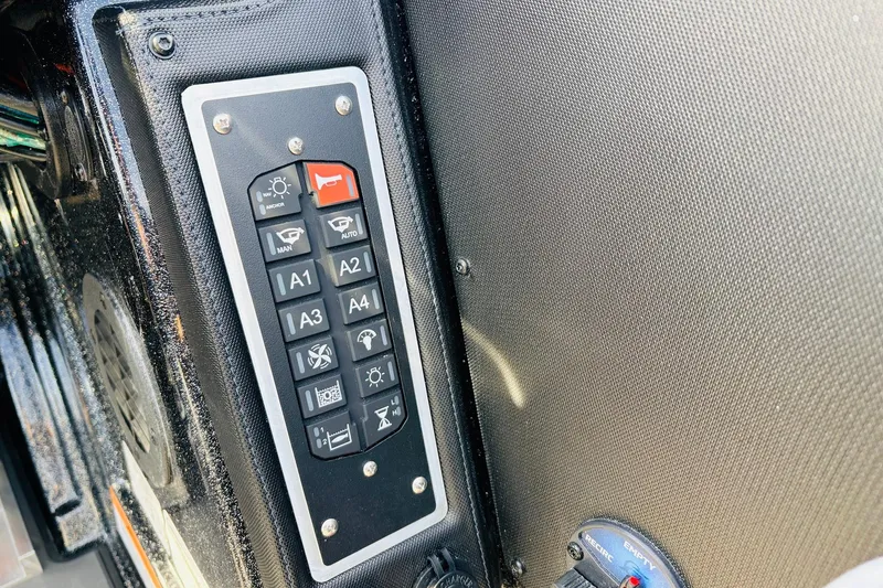 Slide: The Image of Control panel of 2026 Ranger Z521 boat with various function buttons. - 47
