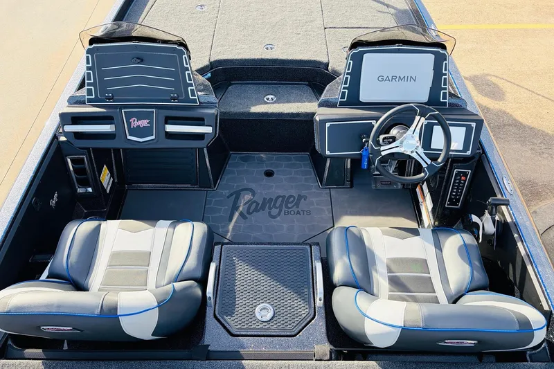 Slide: The Image of 2026 Ranger Z521 boat interior with dual seats, steering wheel, and Garmin displays. - 36