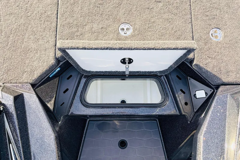 Slide: The Image of 2026 Ranger Z521 boat storage compartment with open lid, showcasing interior design. - 31