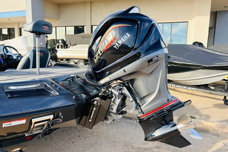 Slide: The Image of 2026 Ranger Z521 boat with Yamaha outboard motor, parked outdoors. - 7
