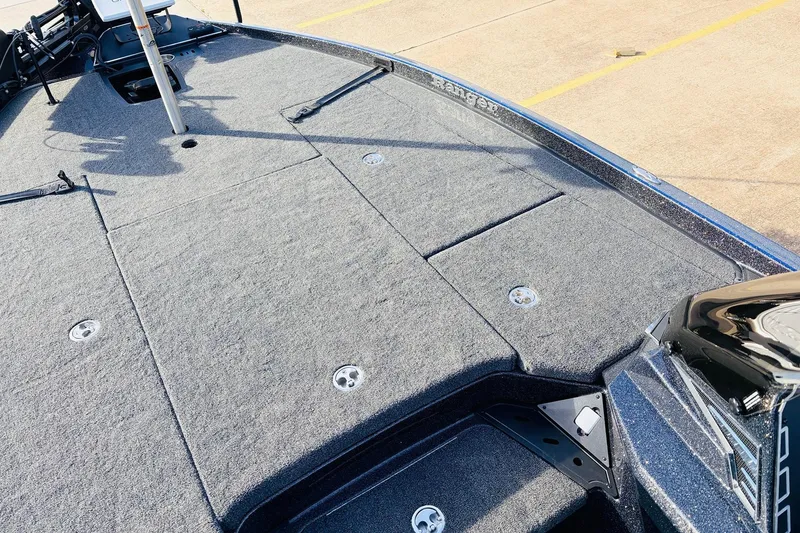 Slide: The Image of 2026 Ranger Z521 boat deck with carpeted surface and storage compartments. - 19