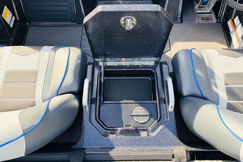 Slide: The Image of 2026 Ranger Z521 boat interior with open storage compartment between two seats. - 49