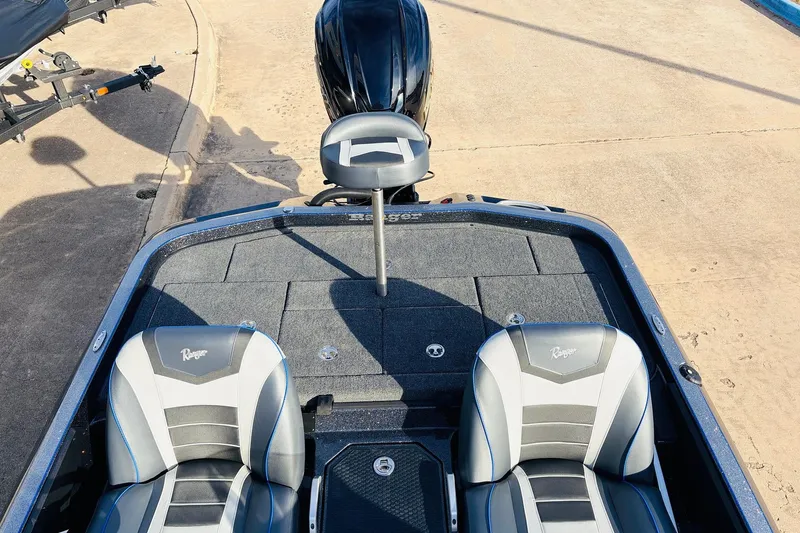 Slide: The Image of 2026 Ranger Z521 boat interior with dual seats and motor, parked on concrete. - 50