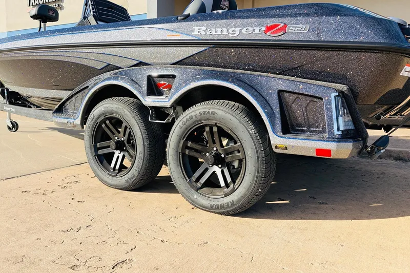 Slide: The Image of 2026 Ranger Z521 boat trailer with black wheels on a concrete surface. - 10