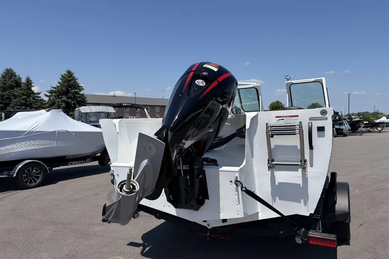 Slide: The Image of 2027 Crestliner 1850 Commander boat with powerful outboard motor, parked outdoors. - 4