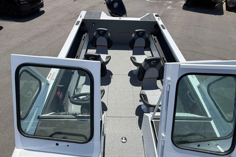 Slide: The Image of 2027 Crestliner 1850 Commander boat interior with seating and steering wheel, viewed from above. - 16