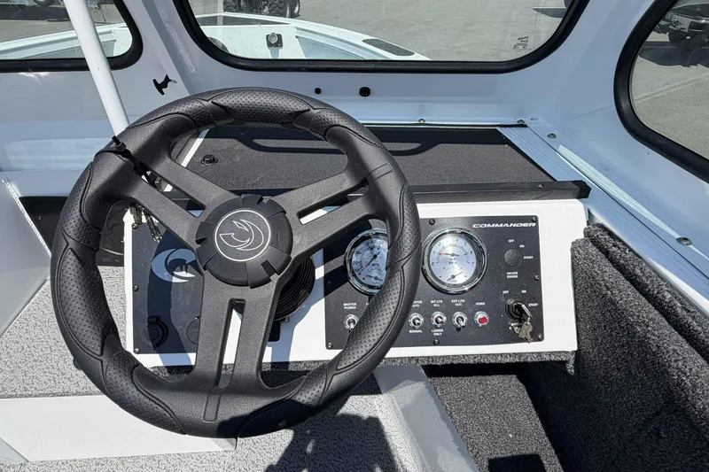 Slide: The Image of Steering wheel and dashboard of 2027 Crestliner 1850 Commander boat, featuring gauges and controls. - 10