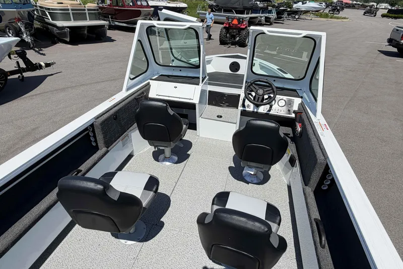 Slide: The Image of 2027 Crestliner 1850 Commander boat interior with four seats and steering console. - 5
