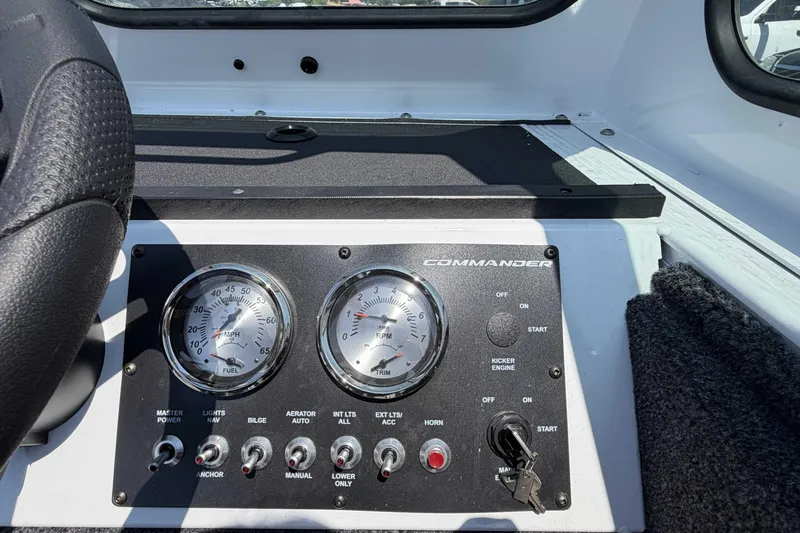 Slide: The Image of Dashboard of 2027 Crestliner 1850 Commander boat with gauges and control switches. - 12