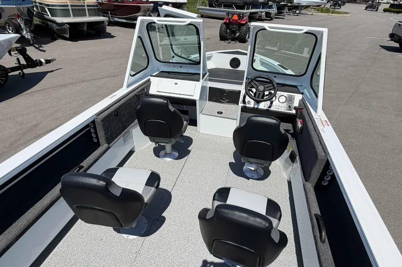 Slide: The Image of 2027 Crestliner 1850 Commander boat interior with four seats and steering console. - 6