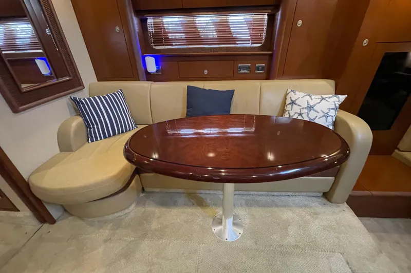 Slide: The Image of Luxurious interior of 2007 Sea Ray 40 Sundancer with elegant seating and wooden table. - 27