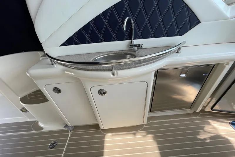 Slide: The Image of Luxurious 2007 Sea Ray 40 Sundancer yacht interior with sink and storage cabinets. - 16