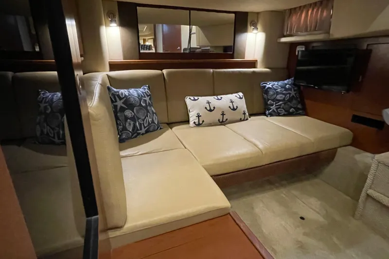 Slide: The Image of Luxurious interior of 2007 Sea Ray 40 Sundancer yacht with beige seating and nautical-themed pillows. - 31