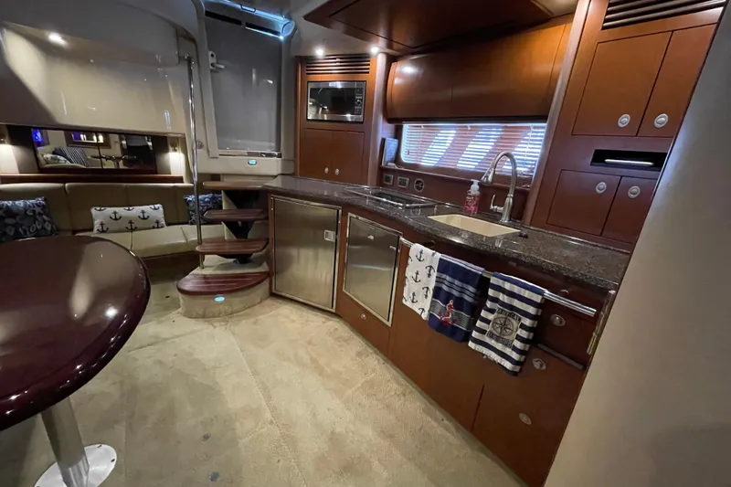 Slide: The Image of Luxurious interior of a 2007 Sea Ray 40 Sundancer yacht with modern kitchen amenities. - 25