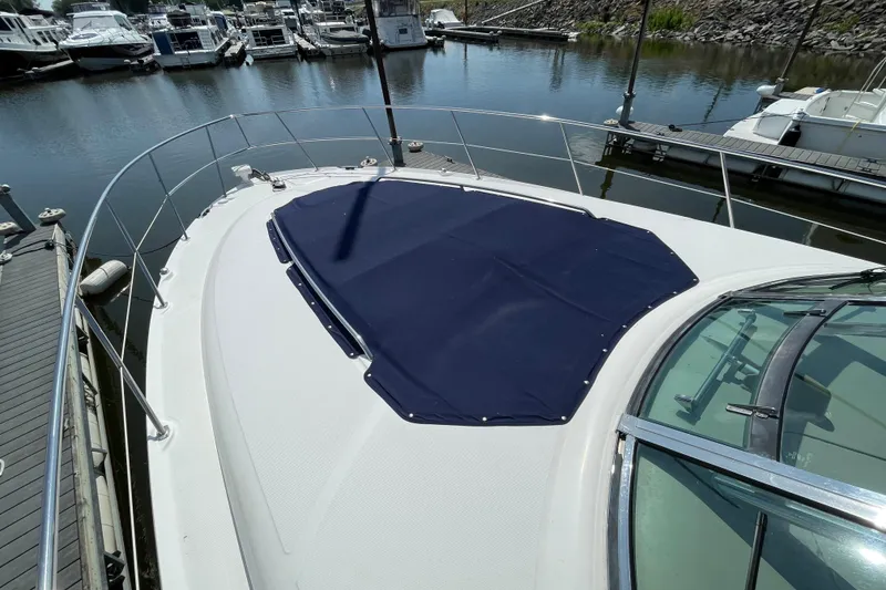Slide: The Image of 2007 Sea Ray 40 Sundancer yacht docked at marina, featuring a covered bow area. - 5