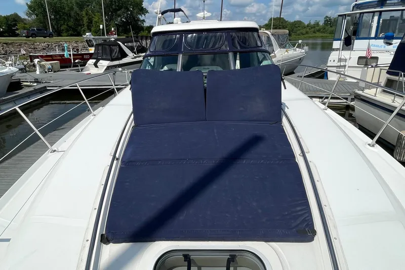 Slide: The Image of 2007 Sea Ray 40 Sundancer yacht with blue sunpad, docked at marina. - 9