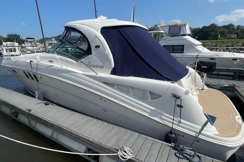 Slide: The Image of 2007 Sea Ray 40 Sundancer yacht docked at marina under clear blue sky. - 3