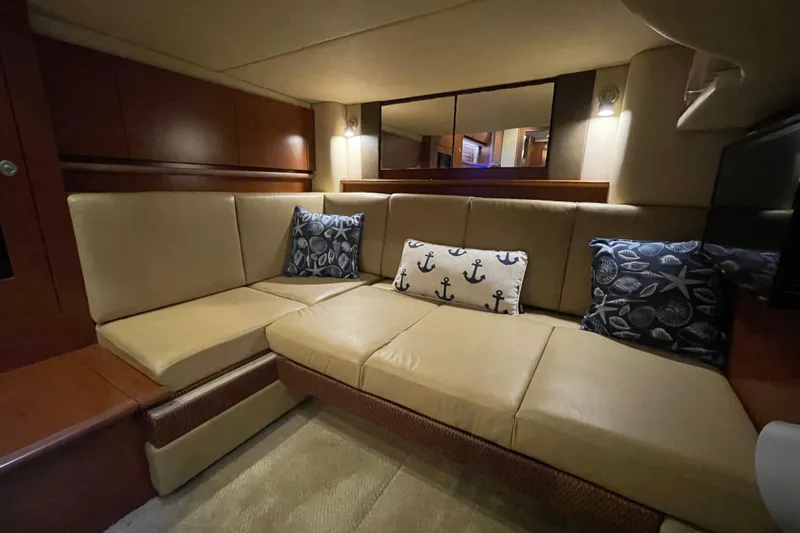 Slide: The Image of Luxurious interior of 2007 Sea Ray 40 Sundancer with beige seating and nautical-themed pillows. - 28