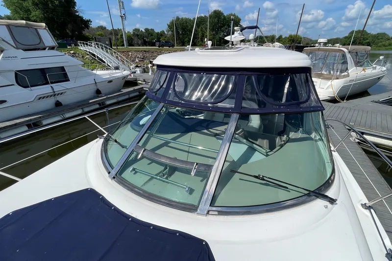Slide: The Image of 2007 Sea Ray 40 Sundancer yacht docked at marina under blue sky. - 8