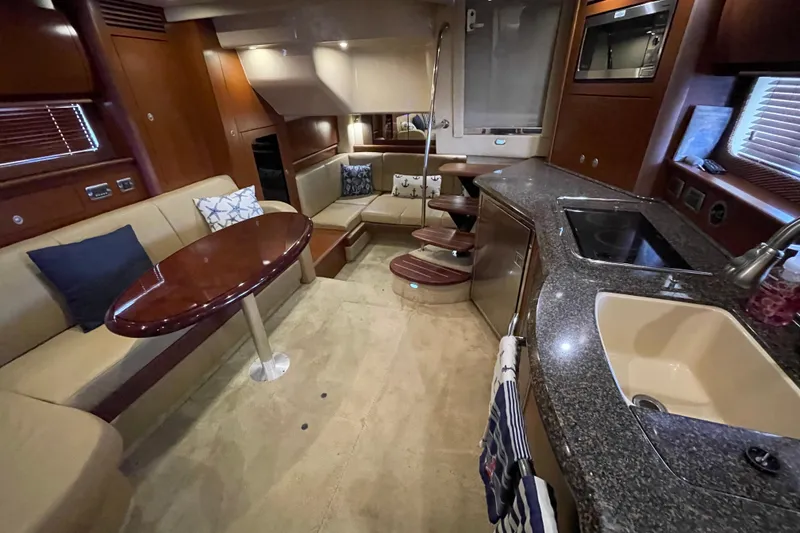 Slide: The Image of Luxurious interior of a 2007 Sea Ray 40 Sundancer yacht with elegant seating and modern kitchen. - 21