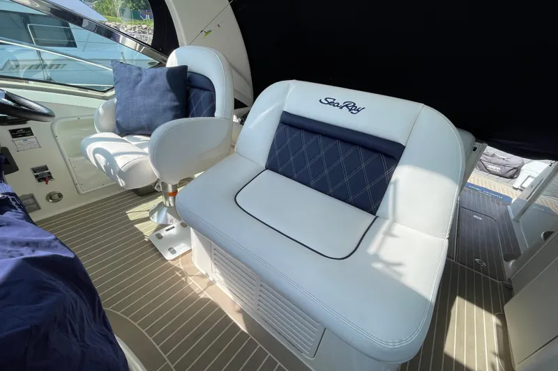 Slide: The Image of Interior seating of 2007 Sea Ray 40 Sundancer yacht with white and navy cushions. - 13