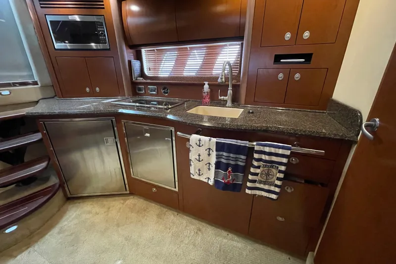Slide: The Image of Luxurious 2007 Sea Ray 40 Sundancer yacht kitchen with modern appliances and nautical decor. - 29