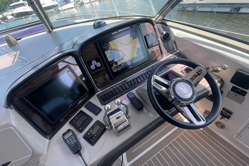 Slide: The Image of Helm of 2007 Sea Ray 40 Sundancer with navigation screens and controls. - 19