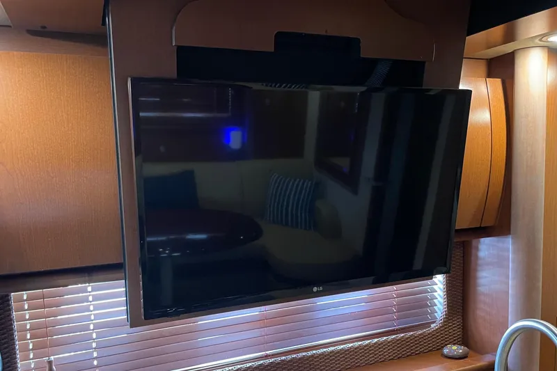 Slide: The Image of Flat-screen TV in 2007 Sea Ray 40 Sundancer yacht interior, with wooden cabinetry. - 38