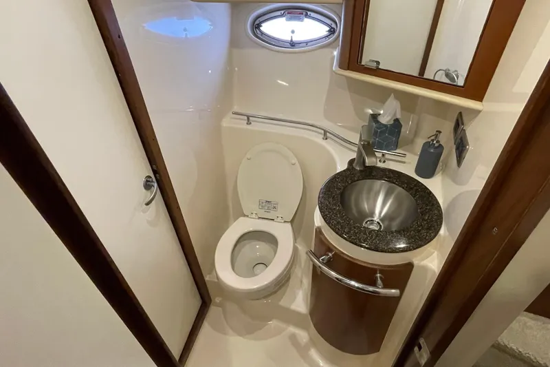 Slide: The Image of Luxurious 2007 Sea Ray 40 Sundancer yacht bathroom with modern fixtures and porthole window. - 36