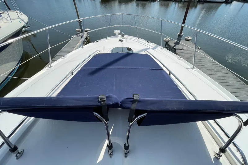 Slide: The Image of 2007 Sea Ray 40 Sundancer yacht bow with blue sunpad, docked at marina. - 10