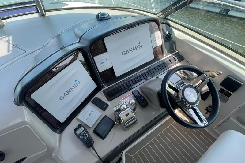 Slide: The Image of Cockpit of 2007 Sea Ray 40 Sundancer with Garmin navigation system and steering wheel. - 18