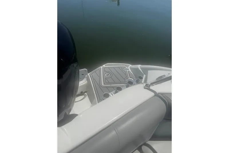 Slide: The Image of 2021 NauticStar 243 DC boat interior with seating and cup holders. - 19